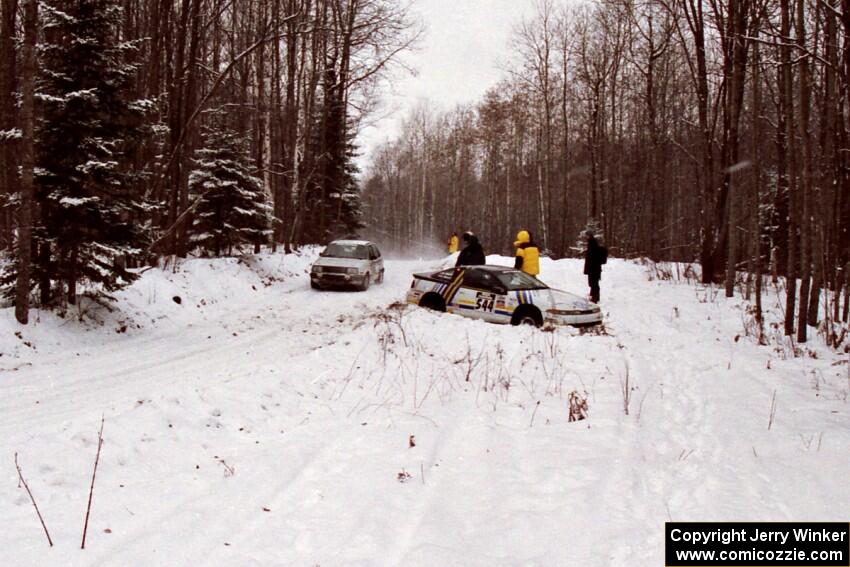 Dan Malott / Matt Malott Eagle Talon gets stuck on SS4, Avery Lake , as Russ Rosendale / Robin Winter VW Golf passes by.