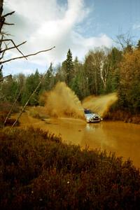 Mark Nelson / Alex Gelsomino Mitsubishi Lancer Evo VI at the midpoint water crossing on SS2, Herman.