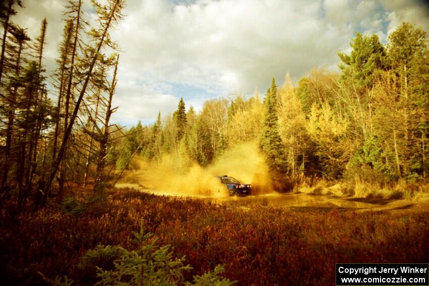 Mark Lovell / Steve Turvey Subaru WRX STi at the midpoint water crossing on SS2, Herman.