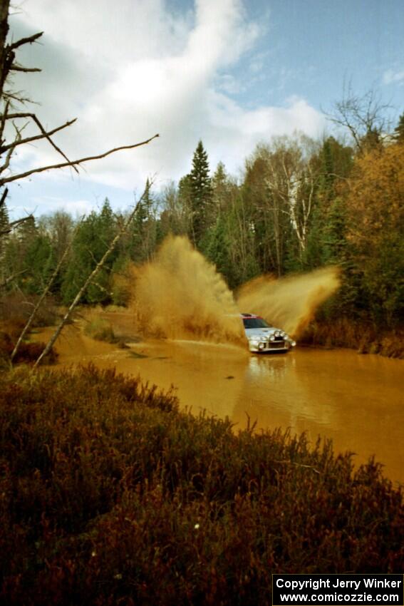 Mark Nelson / Alex Gelsomino Mitsubishi Lancer Evo VI at the midpoint water crossing on SS2, Herman.