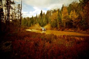 Eric Burmeister / Eric Adams Mazda Protege' MP3 at the midpoint water crossing on SS2, Herman.