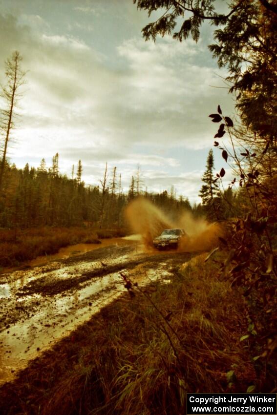 Mike Hurst / Rob Bohn Ford Mustang at the midpoint water crossing on SS2, Herman.