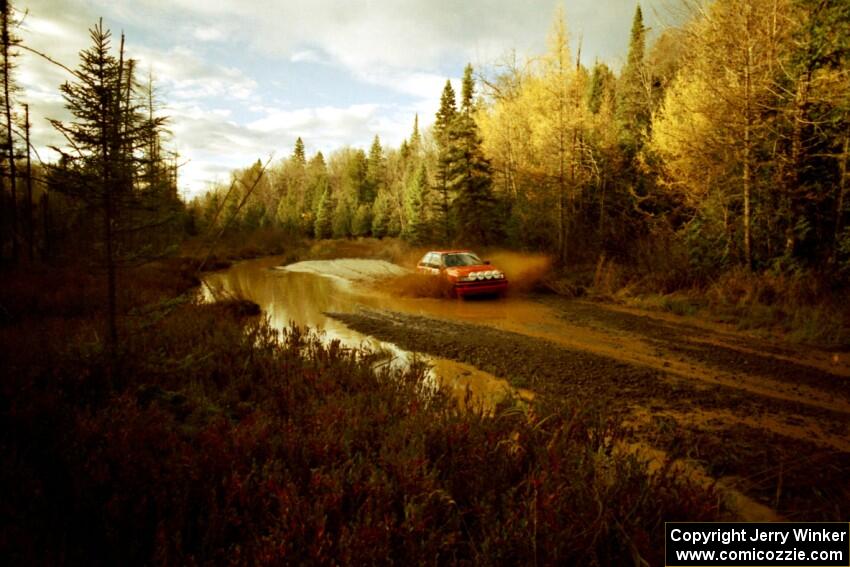 Gail Truess / Pam McGarvey Mazda 323GTX at the midpoint water crossing on SS2, Herman.