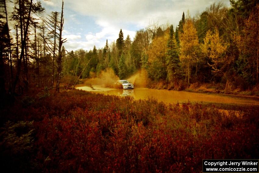 Eric Burmeister / Eric Adams Mazda Protege' MP3 at the midpoint water crossing on SS2, Herman.