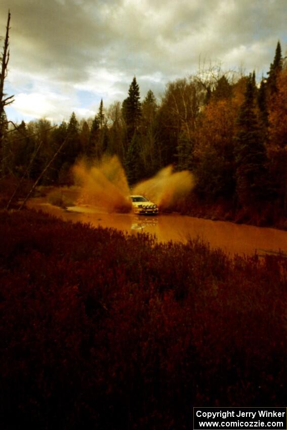 Rod Dean / Nichole Dean Plymouth Laser RS at the midpoint water crossing on SS2, Herman.