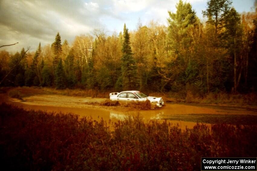 Paul Dunn / Rebecca Dunn Mitsubishi Lancer Evo IV at the midpoint water crossing on SS2, Herman.