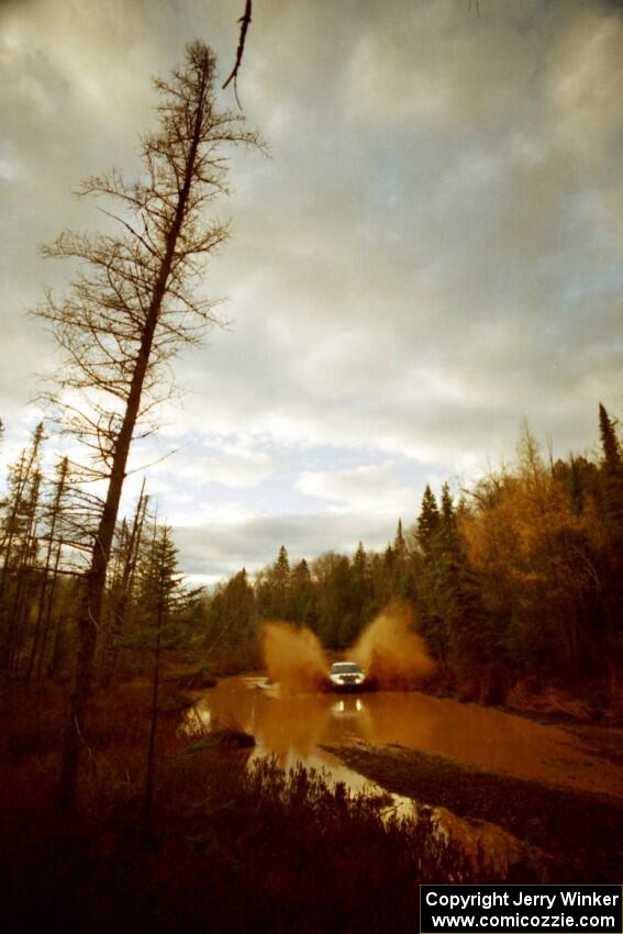 Micah Wiitala / Jane Wiitala Saturn SL2 at the midpoint water crossing on SS2, Herman.