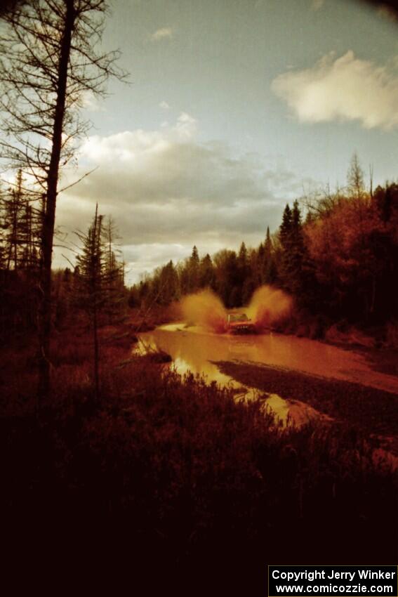 Paul Flores / Sean Figgins Nissan Pickup at the midpoint water crossing on SS2, Herman.