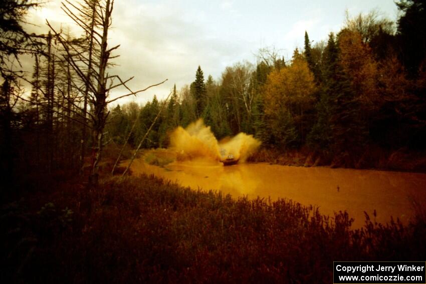 Mary Utecht / Heidi Meyers Dodge Omni GLH Turbo at the midpoint water crossing on SS2, Herman.