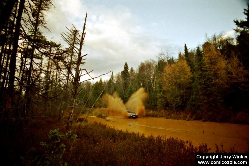 Dan Moore / John Hopponen Suzuki Swift GTi at the midpoint water crossing on SS2, Herman.