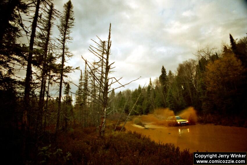 Alex Timmermans / Jason Mendez Datsun 510 at the midpoint water crossing on SS2, Herman.