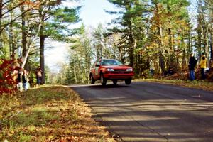 Gail Truess / Pam McGarvey Mazda 323GTX at the midpoint jump on SS16, Brockway Mt.