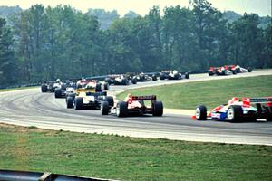 The front half of the field comes through turn one on the first lap.