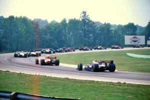 The back half of the field comes through turn one on the first lap.