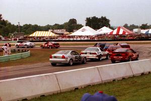 Bill Cooper's Chevy Camaro and Neil Hanneman's Eagle Talon TSi lead a gaggle of cars through turn 5.