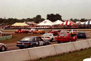 Scott Hoerr's Olds Achieva SCX, Jeff Nowicki's Chevy Camaro and Rick Bye's Porsche 968 lead a gaggle of cars through turn 5.