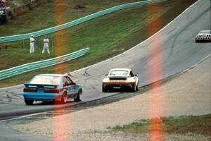 R.K. Smith's Chevy Corvette ahead of Nick Ham's Porsche 911 Turbo and Andy Pilgrim's Ford Mustang Saleen SC