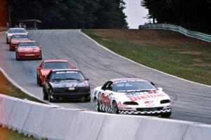 Six cars stream downhill into turn 5.