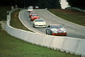 Seven cars stream downhill into turn 5.