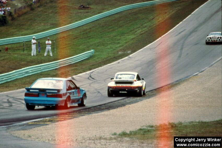 R.K. Smith's Chevy Corvette ahead of Nick Ham's Porsche 911 Turbo and Andy Pilgrim's Ford Mustang Saleen SC