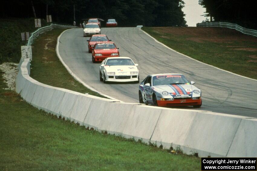 Seven cars stream downhill into turn 5.