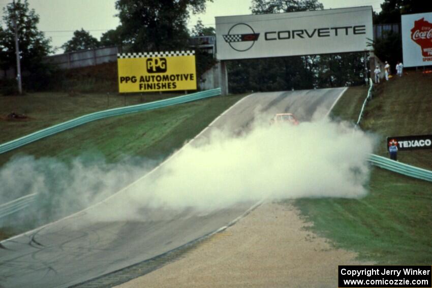 Richard Holdener's Ford Mustang Cobra smokes heavily out of turn 5.