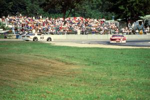 Bill Gray's Chevy Camaro spins, Walter Payton's Ford Mustang passes by.