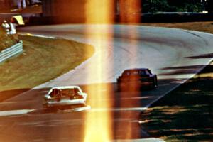Bill Gray's Chevy Camaro, drags bodywork uphill toward turn 13.
