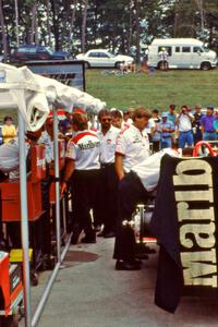 Rick Mears, dead center, helps with the Penske crew.