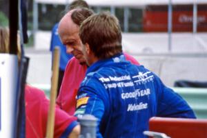 Scott Goodyear and Derrick Walker converse on pit lane.