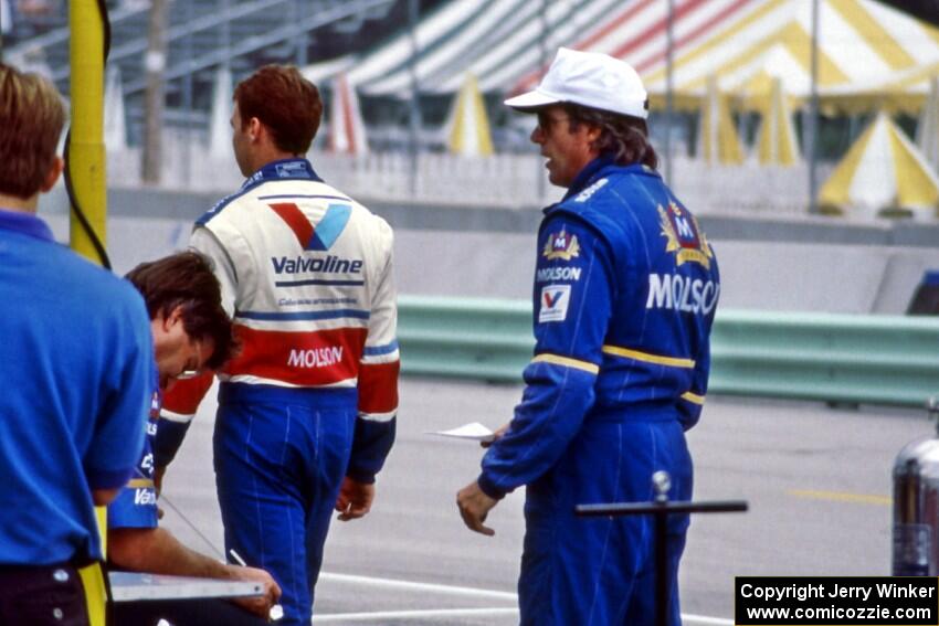 Al Unser, Jr. and Danny Sullivan on pit lane.