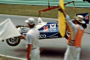 Adrian Fernandez's Lola T-93/07/Chevy comes by on the hook after colliding with the wall at the kink.