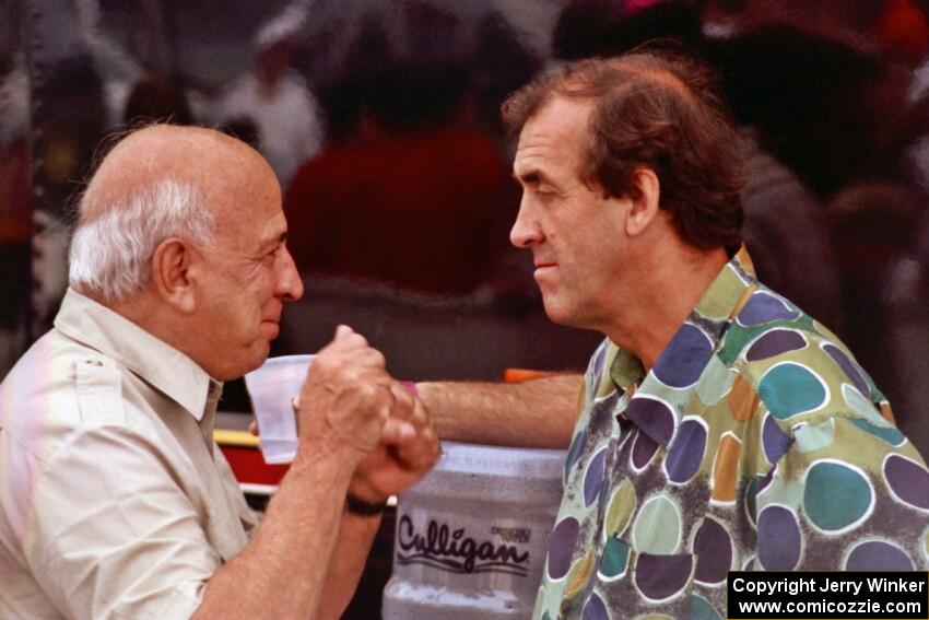 Mike Rahal and David Hobbs converse in the paddock.