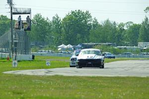 Tom Fuehrer's ITE-1 Ford Mustang and Mike Campbell's ITA BMW 325is take the checkered flag.