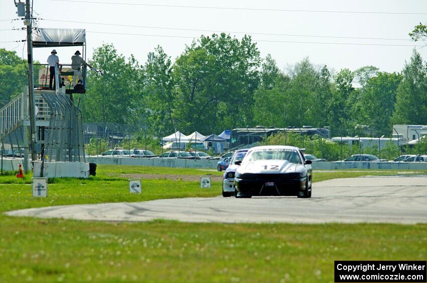 Tom Fuehrer's ITE-1 Ford Mustang and Mike Campbell's ITA BMW 325is take the checkered flag.