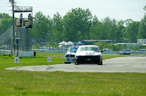 Tom Fuehrer's ITE-1 Ford Mustang and Mike Campbell's ITA BMW 325is take the checkered flag.