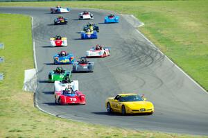 The field streams through turns 5 and 6 on the pace lap.