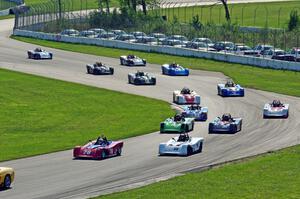 The field streams through turns 10 and 11 on the pace lap.