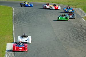 The field streams through turns 5 and 6 on the first lap.