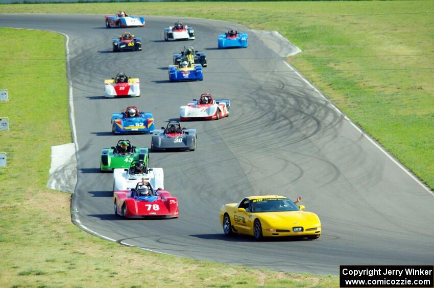 The field streams through turns 5 and 6 on the pace lap.