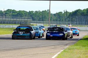 Mark Utecht's STL Honda Civic and Samantha Silver's Spec Miata Mazda Miata on the front row of the small production field.