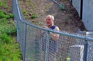 Jon Anderson spectates from the turn 13 fence.