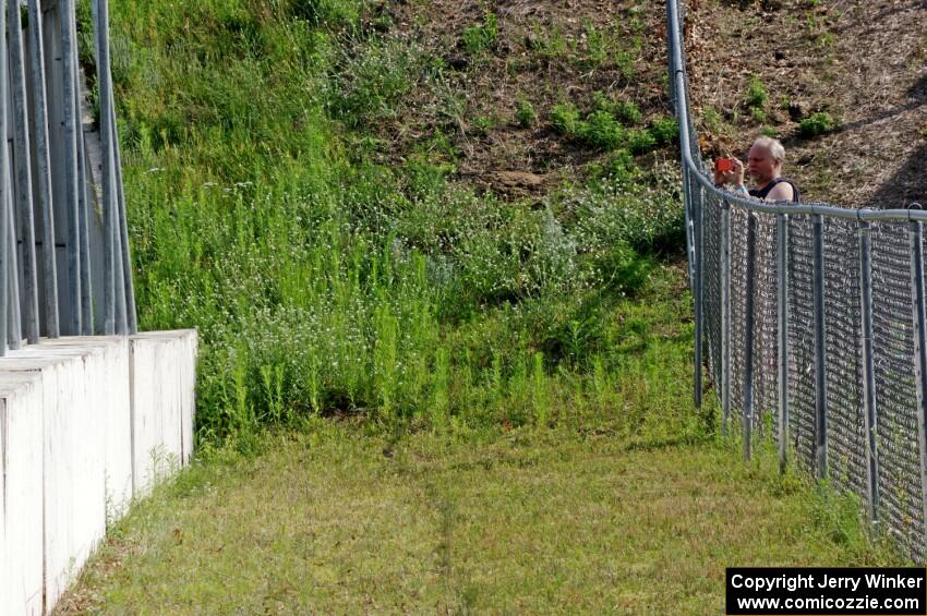 Jon Anderson takes photos from the turn 13 fence.