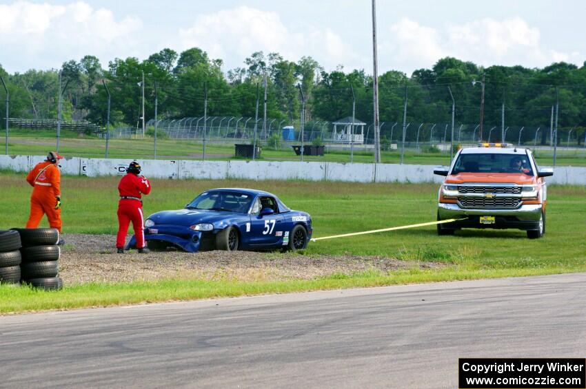 Samantha Silver's Spec Miata Mazda Miata gets pulled from the gravel trap at turn 12.
