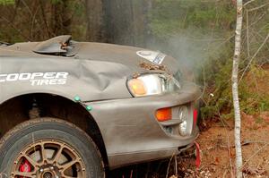 Jordan Locher / Tom Addison Subaru Impreza 2.5RS up against a tree after rolling on SS1.