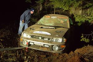 Jordan Locher / Tom Addison Subaru Impreza 2.5RS is pulled from the woods after rolling on SS1.