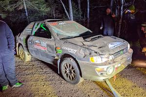 Jordan Locher / Tom Addison Subaru Impreza 2.5RS is pulled from the woods after rolling on SS1.