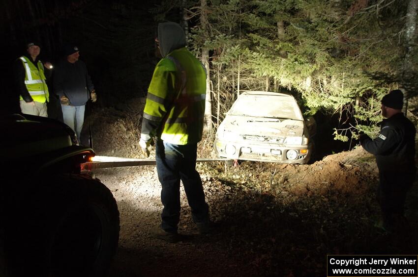 Jordan Locher / Tom Addison Subaru Impreza 2.5RS is pulled from the woods after rolling on SS1.
