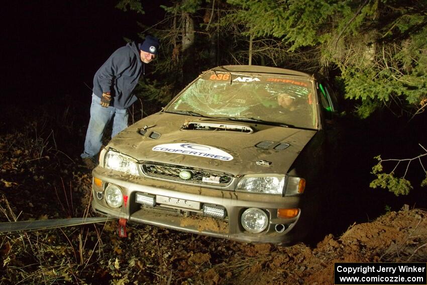 Jordan Locher / Tom Addison Subaru Impreza 2.5RS is pulled from the woods after rolling on SS1.