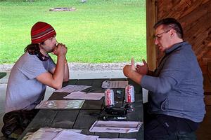 Steve Gingras discusses strategy with a new co-driver prior to the start of the rally.